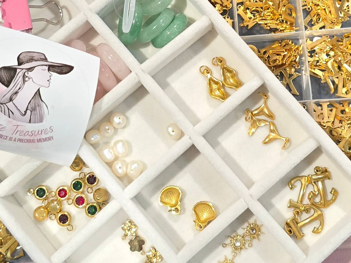 Assorted birthstone gems and gold jewelry charms for personalization