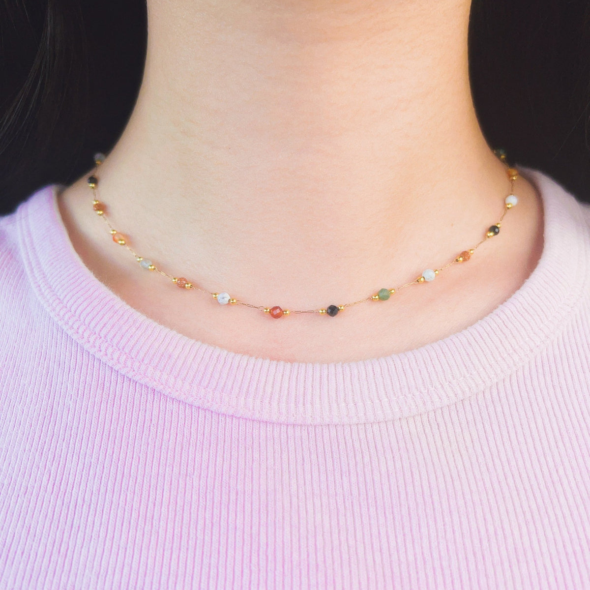 Gemma Dainty Necklace worn at the collarbone with a light pink top.